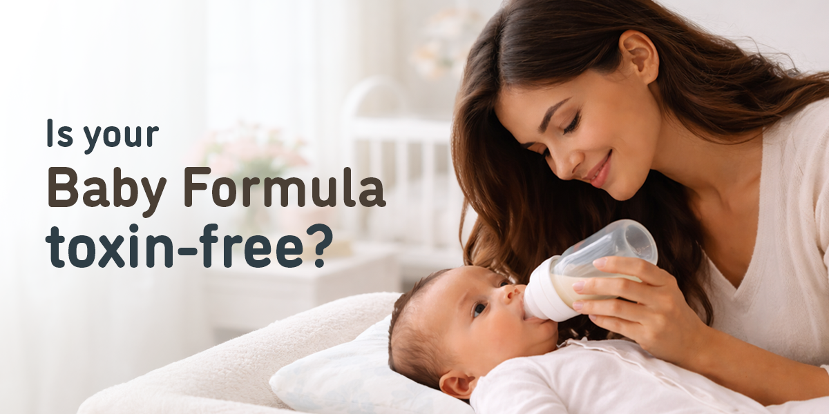 Mother bottle-feeding a baby with infant formula tested for cereulide and heavy metals to ensure infant safety.